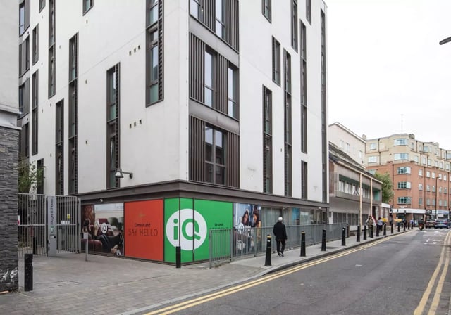 Building with advertisements and entrance exterior at iQ Magenta House in London Student Accommodation