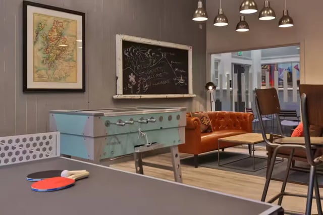 Ping pong table foosball table orange sofa living room at Willowbank in Glasgow Student Accommodation