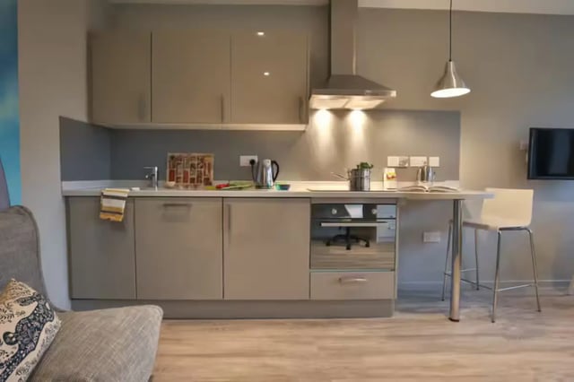 Modern grey kitchen with oven and bar stool kitchen at Oldgate House in Huddersfield Student Accommodation