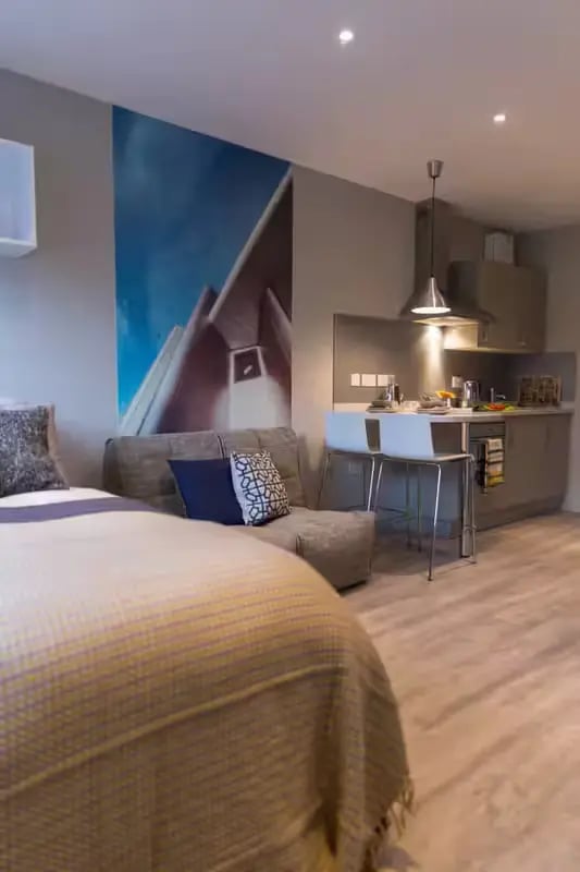 Bed sofa kitchen counter with stools studio apartment at Oldgate House in Huddersfield Student Accommodation