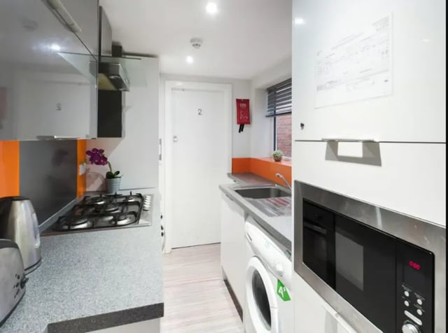 Kitchen with hob sink washing machine and microwave kitchen at 210 Cauldon Road in Stoke-On-Trent Student Accommodation