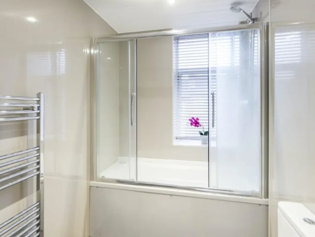 Shower bath with towel rail and orchid bathroom at 210 Cauldon Road in Stoke-On-Trent Student Accommodation