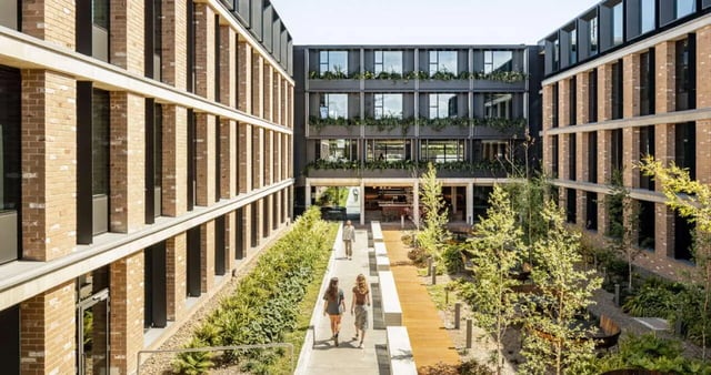 Courtyard with modern buildings people walking exterior at Iglu Summer Hill in Sydney Student Accommodation