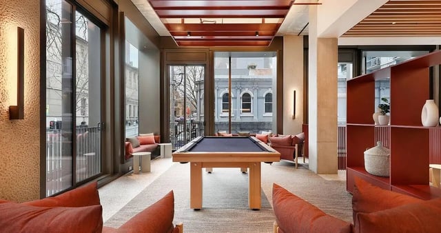Pool table seating and shelving living room at Iglu Melbourne Central in Melbourne Student Accommodation