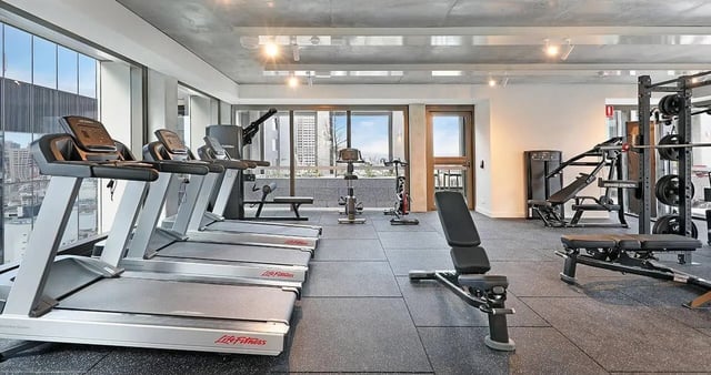 Treadmills weight rack and benches gym area at Iglu Melbourne Central in Melbourne Student Accommodation