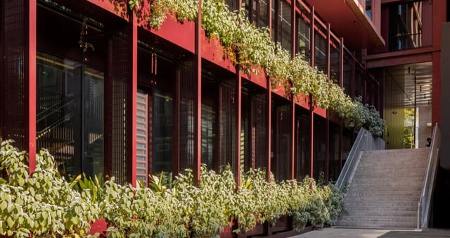 Red building with stairs and plants exterior at Iglu Mascot in Sydney Student Accommodation