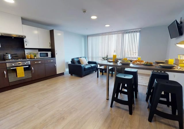 Kitchen sofa table with breakfast food living room at iQ Penworks House in Birmingham Student Accommodation
