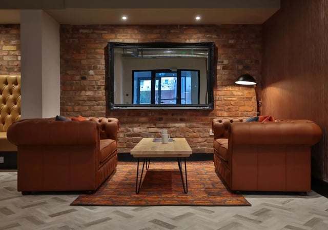 Leather sofas coffee table rug living room at iQ Penworks House in Birmingham Student Accommodation