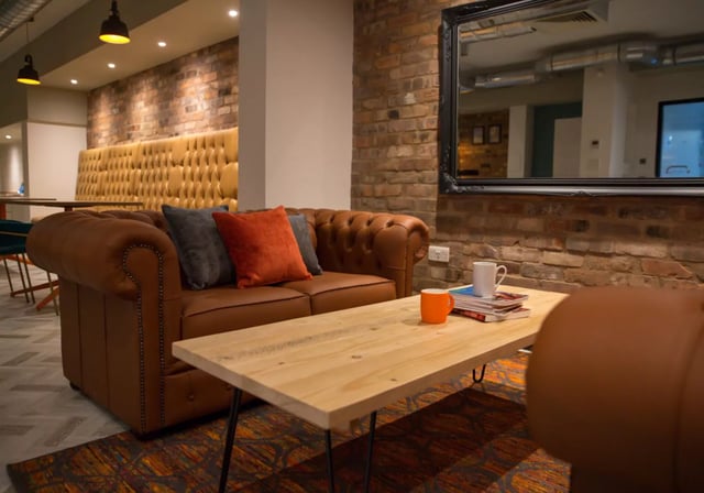Brown leather sofa with cushions coffee table living room at iQ Penworks House in Birmingham Student Accommodation