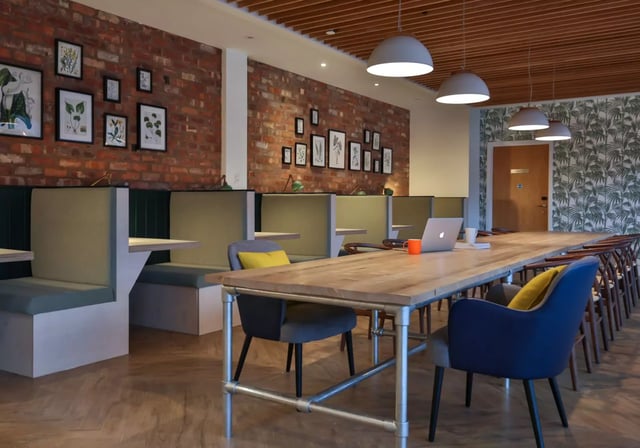 Study area with booths and long communal table at iQ Penworks House in Birmingham Student Accommodation