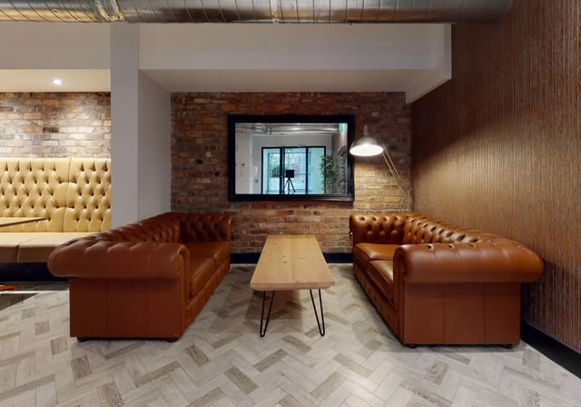 Chesterfield sofas coffee table mirror common area at iQ Penworks House in Birmingham Student Accommodation