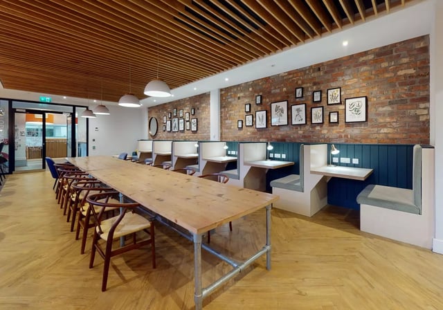 Long table and study booths communal area at iQ Penworks House in Birmingham Student Accommodation