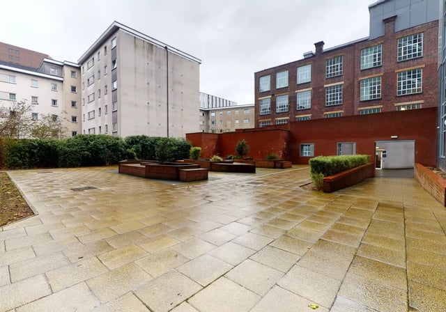 Courtyard with buildings and planters exterior at iQ Penworks House in Birmingham Student Accommodation