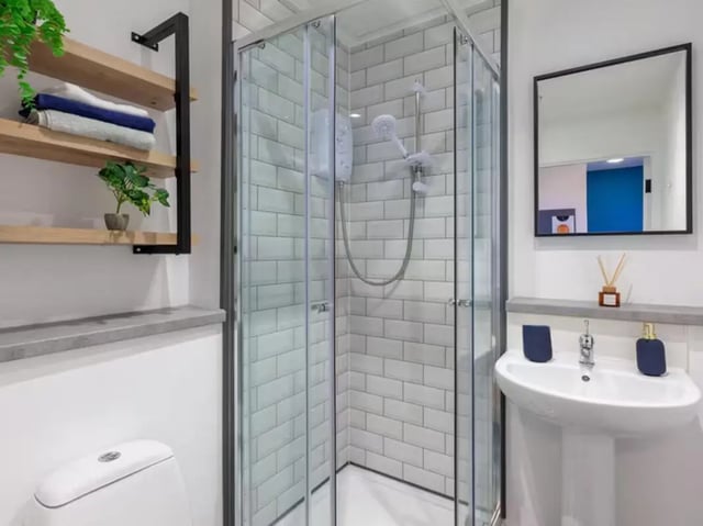 Toilet sink shower with tiled walls and mirror Bathroom at The Priory in Leeds Student Accommodation