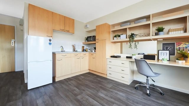 Kitchen and study area with desk and chair at Collegiate King Edward Studios in Exeter Student Accommodation