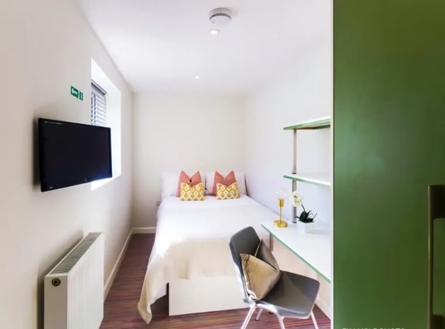 Bed desk chair shelves and TV bedroom at 17 Carlton Road in Stoke-On-Trent Student Accommodation