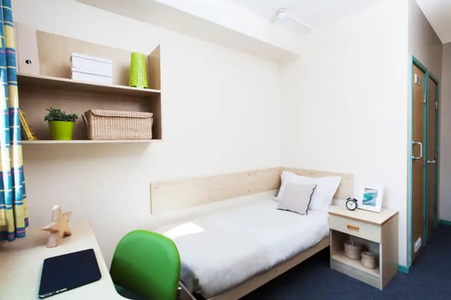 Bed bedside table and shelves student room at Arrad House in Liverpool Student Accommodation