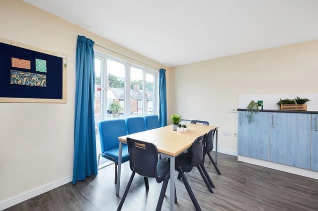 Dining table with chairs and blue bench kitchen area at Point Exe Exeter in Exeter Student Accommodation