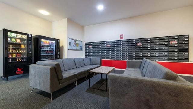 Vending machines couches mailboxes communal lounge at Collegiate Athena Hall in Ipswich Student Accommodation