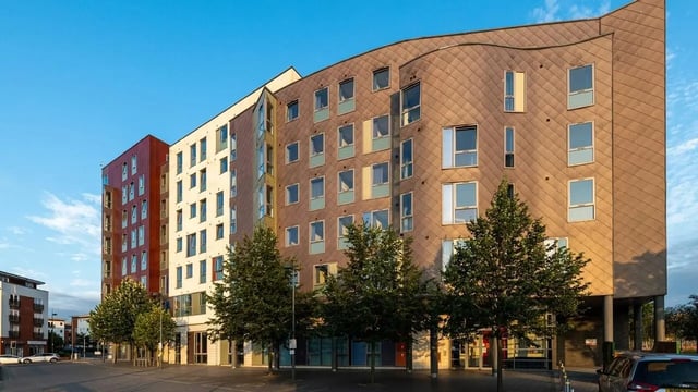 Modern student accommodation building with trees exterior at Collegiate Athena Hall in Ipswich Student Accommodation