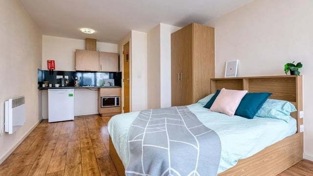 Bed kitchenette wardrobe and heating bedroom at Collegiate Athena Hall in Ipswich Student Accommodation