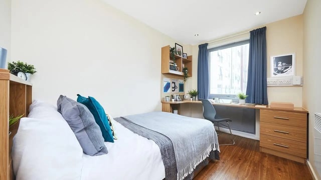 Bed desk chair dresser window bedroom at Collegiate Athena Hall in Ipswich Student Accommodation