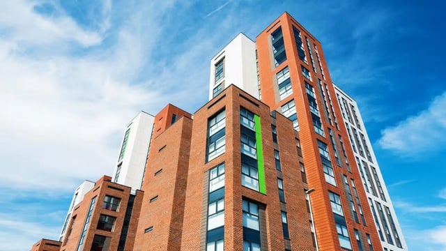Modern brick buildings with white and orange panels exterior at Collegiate Merlin Heights in Leicester Student Accommodation