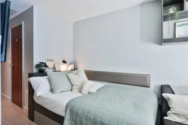 Bed pillows blankets and a shelf Bedroom at Windsor House in Cardiff Student Accommodation