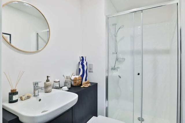 Sink soap dispenser shower and toiletries bathroom at St Mark's Court in Leeds Student Accommodation