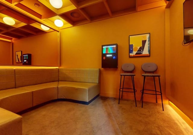 Corner sofa jukebox artwork and bar stools common area at iQ Aldgate in London Student Accommodation