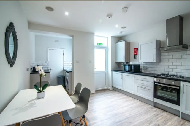 White dining table four chairs ornate mirror kitchen area at 18 Cauldon Road in Stoke-On-Trent Student Accommodation