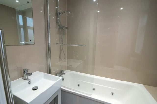 Modern white sink with mirror and bathtub bathroom at 18 Cauldon Road in Stoke-On-Trent Student Accommodation