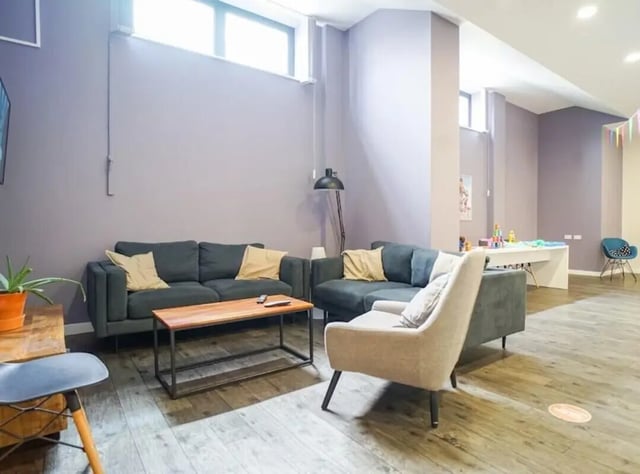 Two sofas coffee table lamp chair living area at Beaverbank Place in Edinburgh Student Accommodation