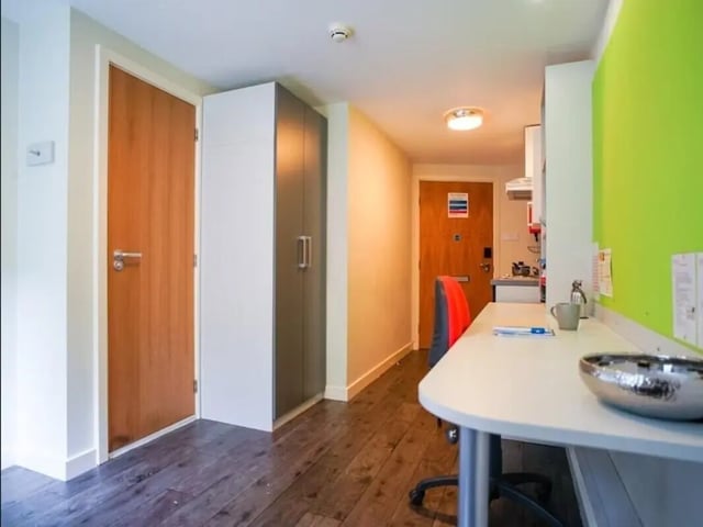 Wooden door wardrobe desk chair student room interior at Beaverbank Place in Edinburgh Student Accommodation