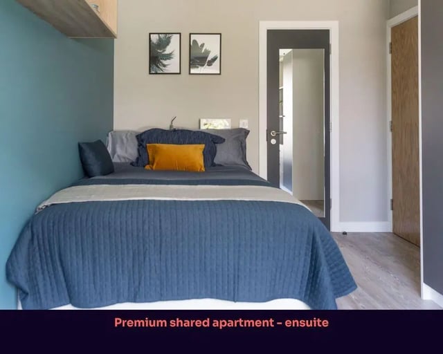 Bed with blue quilt and pillows bedroom at Victoria Point in Manchester Student Accommodation