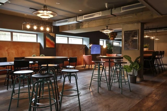 Round tables bar stools and lounge seating common area at Victoria Point in Manchester Student Accommodation