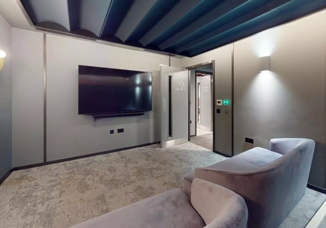 Large TV and couches in a common room at iQ City in London Student Accommodation