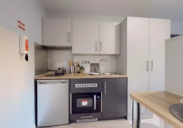 Compact kitchen with fridge microwave sink kitchen. at iQ City in London Student Accommodation