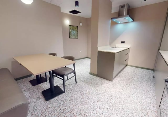 Table chairs sofa kitchen counter living space at iQ City in London Student Accommodation