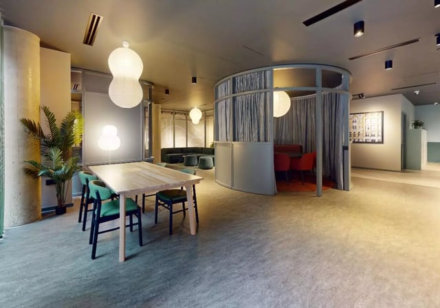 Dining table green chairs curved booth living room at iQ City in London Student Accommodation