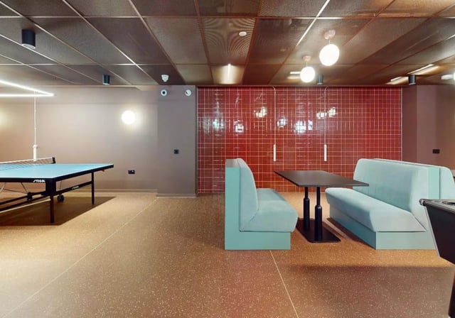 Ping pong table benches table red tile communal area at iQ City in London Student Accommodation