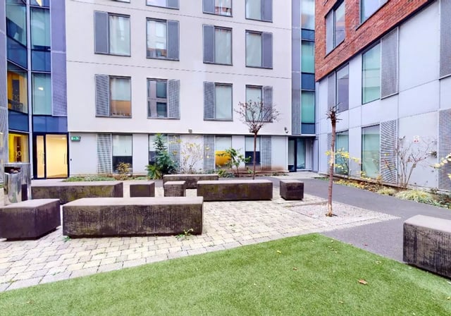 Modern building with concrete seating exterior at iQ City in London Student Accommodation