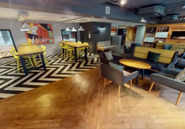 Tables chairs artwork sofas and tables common area at iQ Marsden House in Leeds Student Accommodation