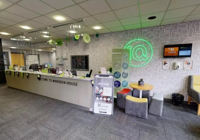 Reception desk with neon sign lounge area lobby at iQ Marsden House in Leeds Student Accommodation
