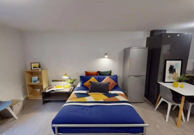 Bed fridge desk shelf and table bedroom at iQ Marsden House in Leeds Student Accommodation