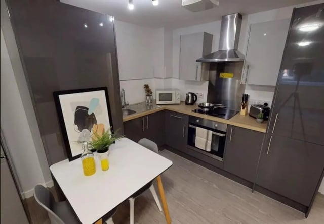 Modern kitchen with dining table artwork and appliances kitchen at iQ Marsden House in Leeds Student Accommodation