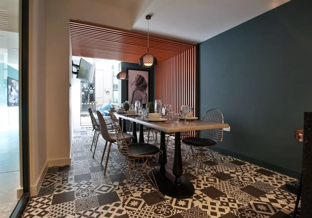Dining table with chairs and place settings dining area at iQ Hammersmith in London Student Accommodation