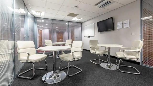 White chairs and tables in a modern room. at Clarendon Street in Nottingham Student Accommodation