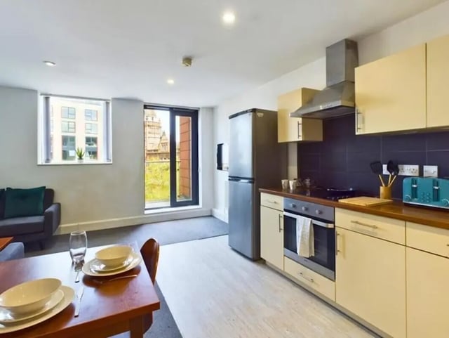 Kitchen area with sofa dining table and window at Windsor Court in Liverpool Student Accommodation