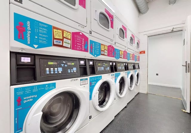 Row of washing machines laundry room at iQ Highbury in London Student Accommodation